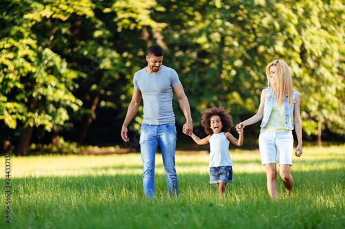 Happy young couple spending time with their daughter