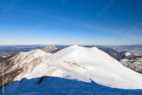 Winter snowy landscape at mountain during a sunny day with blue sky. The Mala Fatra national park in Slovakia, Europe. © Viliam
