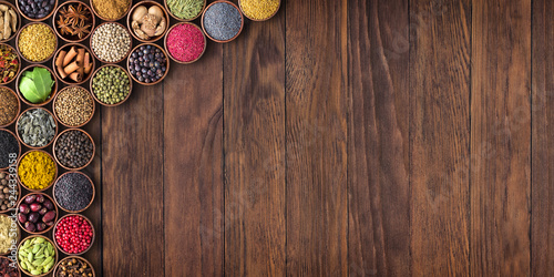 Fototapeta Naklejka Na Ścianę i Meble -  Indian spices and herbs on wooden table.Condiment collection with empty space