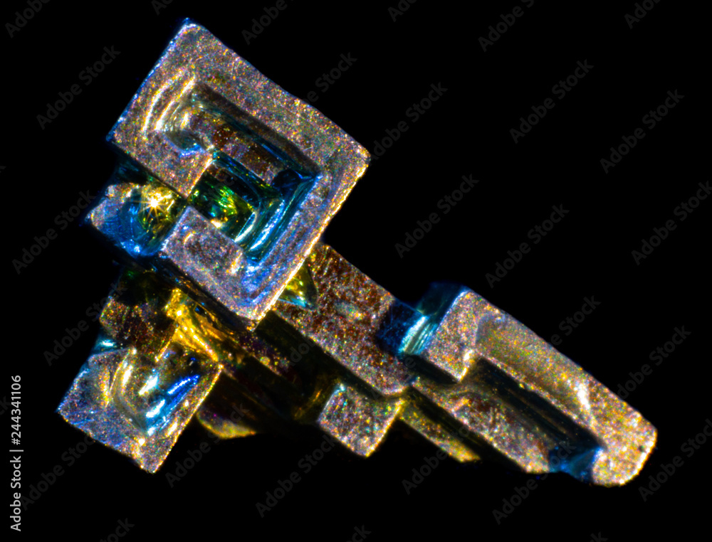 Synthetic iridescent stone bismuth macro on black background Synthetic iridescent stone bismuth macro on black background