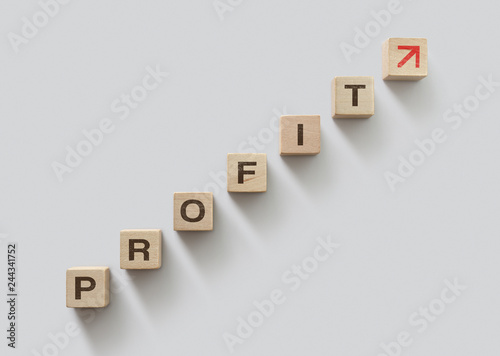 Wooden blocks arranged in stair shape with the word PROFIT. Profit growth, increase profit, raise profit or business growth concept.