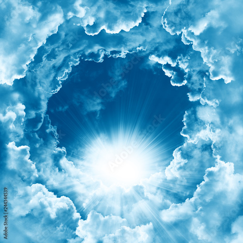 Sky with beautiful cloud and sunshine. Peaceful cloudy sky natural background. Sunny day. Divine shining heaven, light. Religion concept heavenly background