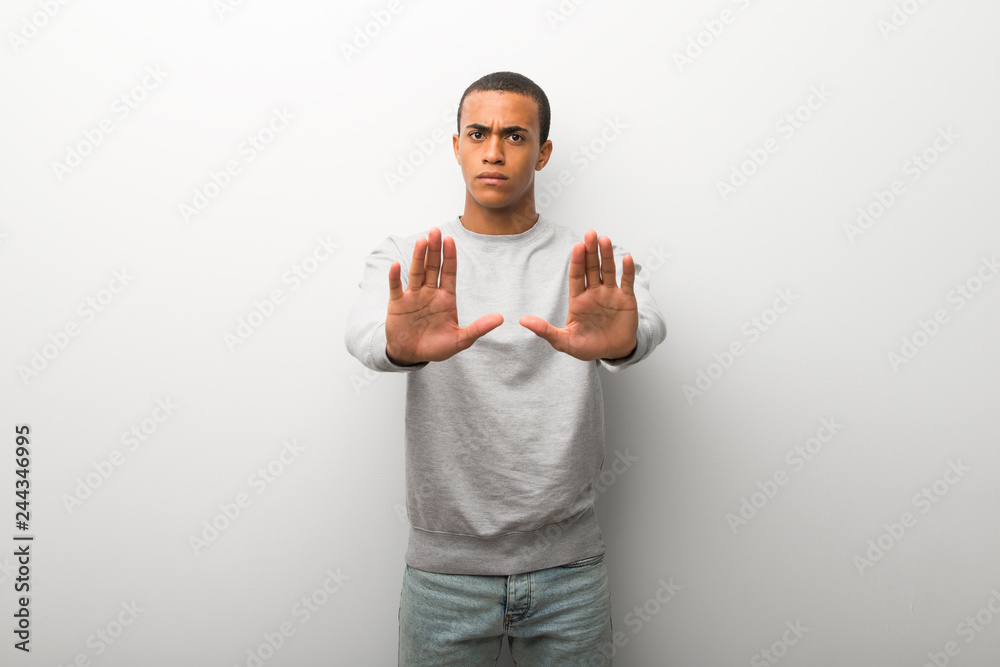 African american man on white wall background making stop gesture for disappointed with an opinion African american man on white wall background making stop gesture for disappointed with an opinion