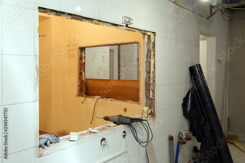Repair and replacement windows in office building, destroyed window partitions of bricks, tiles. Concept construction team, finishing works, redecoration, cabinet reconstruction, wall dismantling