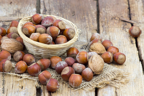 nuts in a basket on old wooden background