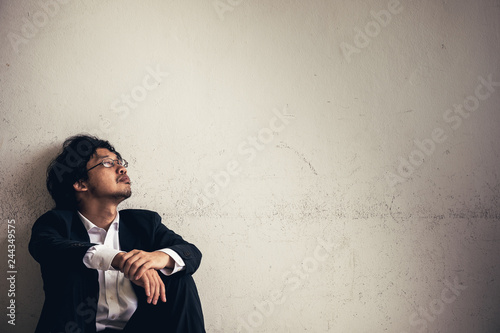 Portraits of Asian businessman stressed from work.anxiety in adult cause to depression and a problem in living that drag you down to feeling sadness,lonely and worried.