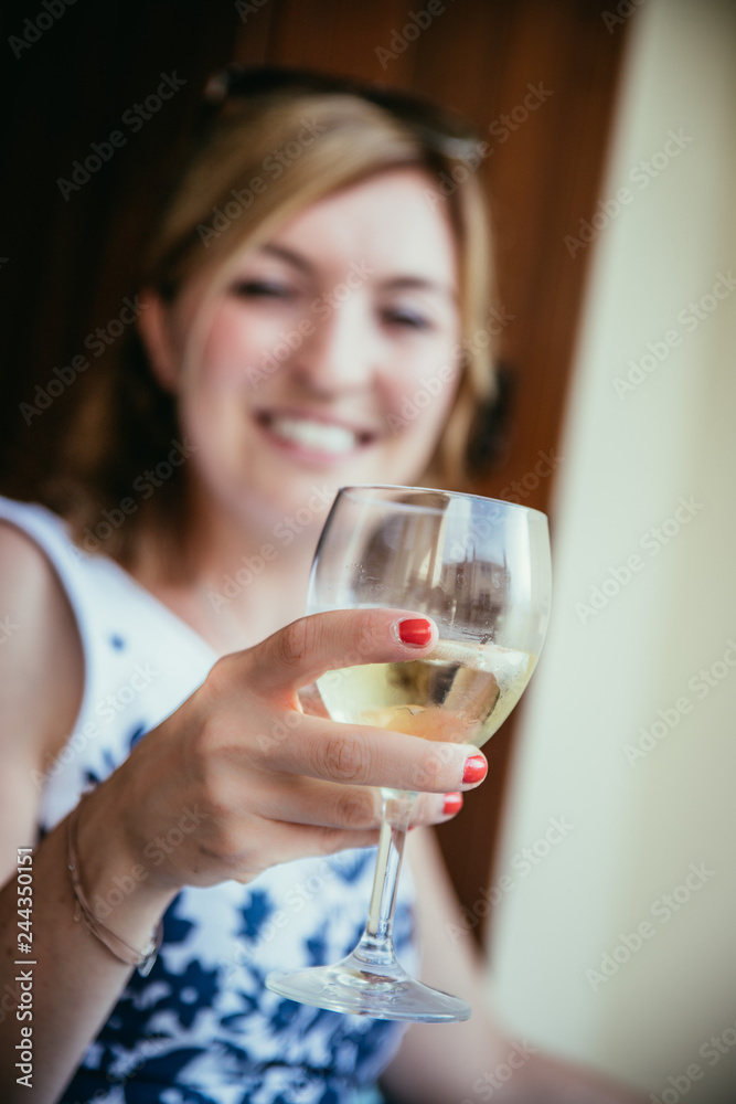 Beautiful young woman is enjoying a glass of wine in the holidays Beautiful young woman is enjoying a glass of wine in the holidays