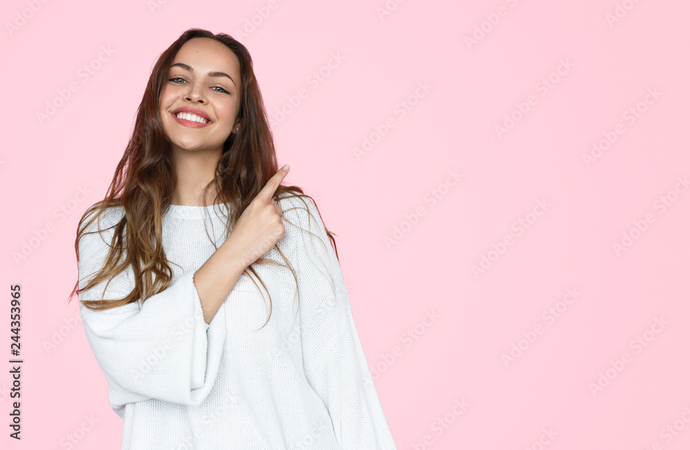 Smiling casual woman pointing back Smiling casual woman pointing back