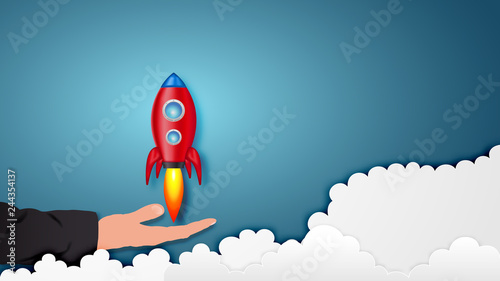 Paper art style of Rocket launch on hand as business start up and sucess concept. vector illustration.