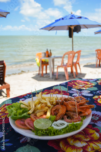 Shrimp dish served at a beach bar on Coroa do Aviao islet, popular destination on the north coast of Pernambuco state (Igarassu, Brazil)