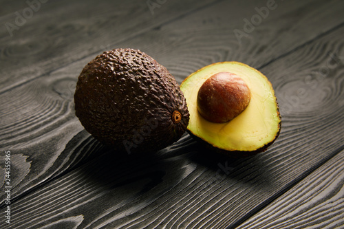 Image of avocado on black wooden background photo