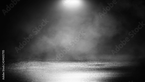 Black background of empty street, room, spotlight illuminates asphalt, smoke photo