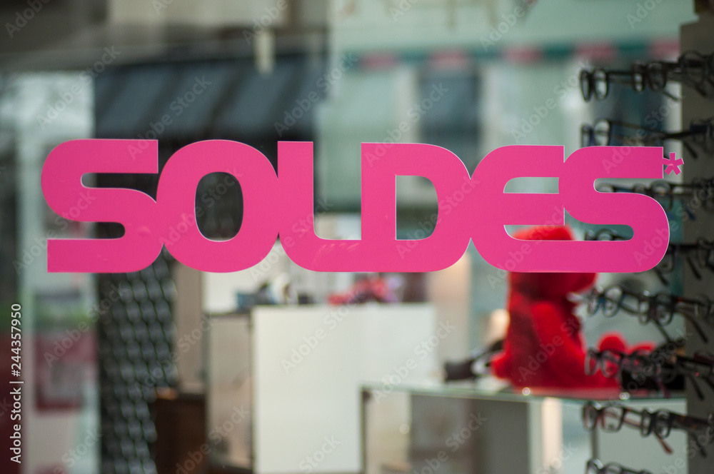 discount sign "SOLDES " in french, the traduction of (sales ) on window in  french fashion store showroom on optic store background Stock Photo | Adobe  Stock