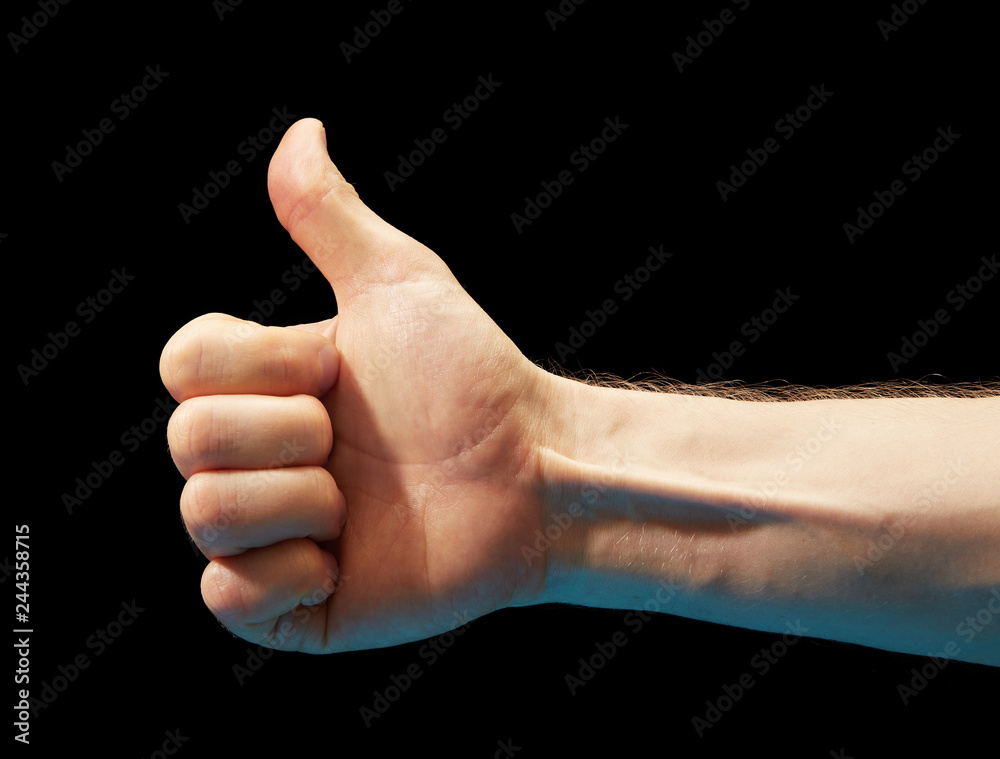 Like. Close up image of human hand with thumb up on black background Like. Close up image of human hand with thumb up on black background