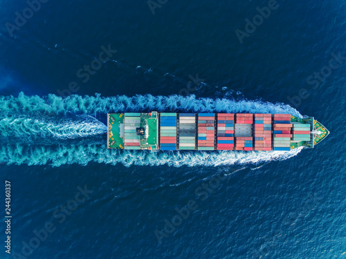 Aerial top view container ship full speed for logistics , import export, shipping or transportation. photo