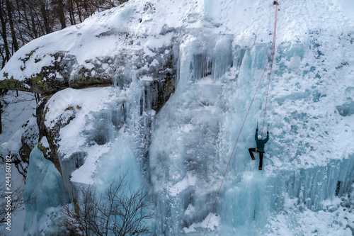 Ice climbing the North Greece, man climbing frozen waterfall. © ververidis