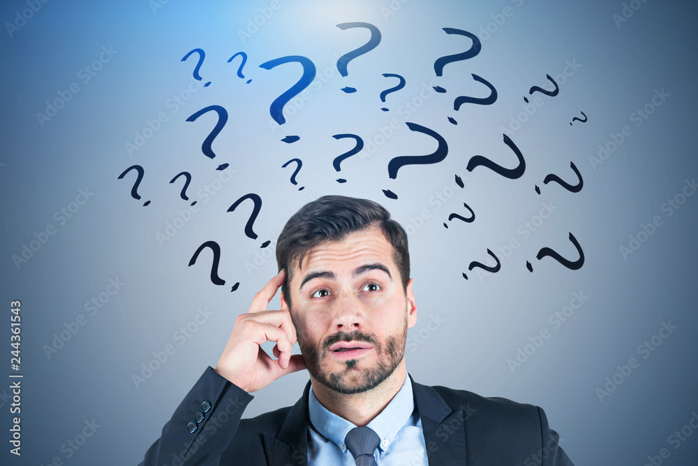 Confused businessman, blue question marks Confused businessman, blue question marks