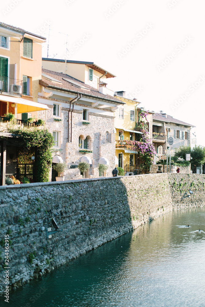Naklejka premium Sirmione,Lombardy,Italy. Picturesque colorful old houses on the streets of Sirmione town-summer resort on Garda Lake