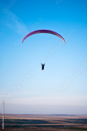 Paraglider in the blue sky