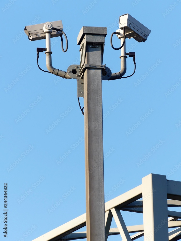 Surveillance cameras monitoring motorway traffic on the M25 in Hertfordshire, England, UK Surveillance cameras monitoring motorway traffic on the M25 in Hertfordshire, England, UK