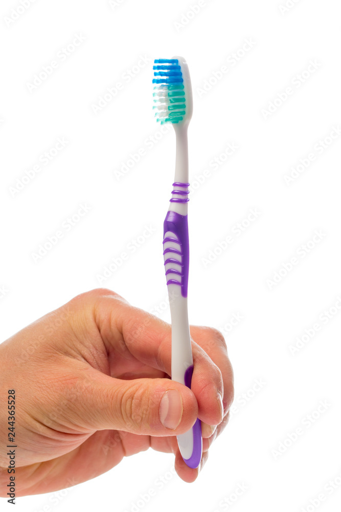 toothbrush in hand on an isolated background toothbrush in hand on an isolated background