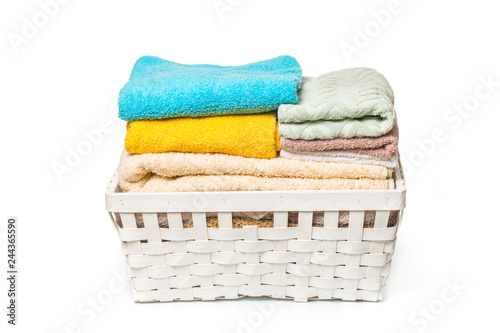 Clothes in a laundry wooden basket isolated on white background.