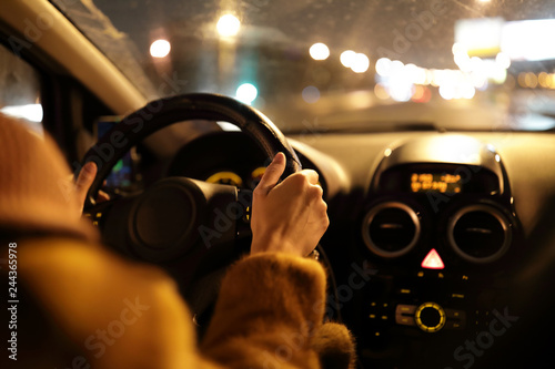 Woman driving car at night