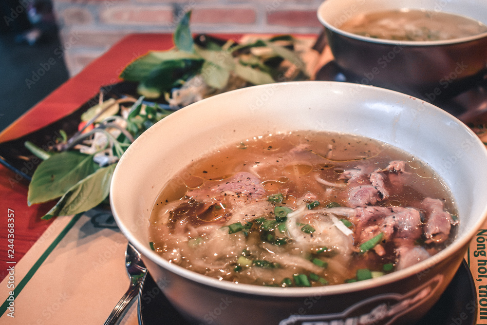 Fresh Pho Bo beef soup in a bowl in Saigon Vietnam Fresh Pho Bo beef soup in a bowl in Saigon Vietnam