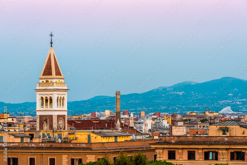 Historic Italian town of Rome, Italy cityscape skyline with high angle view of pink and purple sky with architecture old buildings tower during sunset