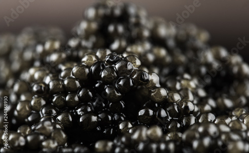 Black caviar background. High quality natural sturgeon caviar closeup. Delicatessen. Beluga caviar backdrop