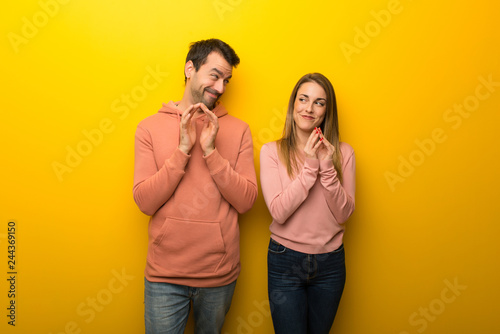 Group of two people on yellow background scheming something