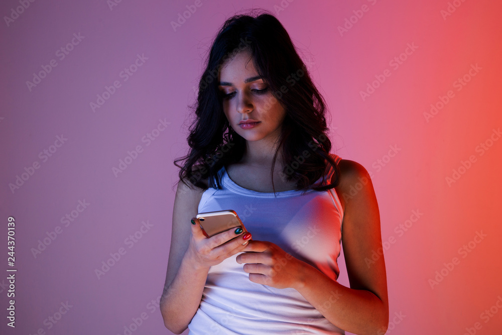 Teen girl excessively sitting at the phone at home. he is a victim of online bullying Stalker social networks Teen girl excessively sitting at the phone at home. he is a victim of online bullying Stalker social networks