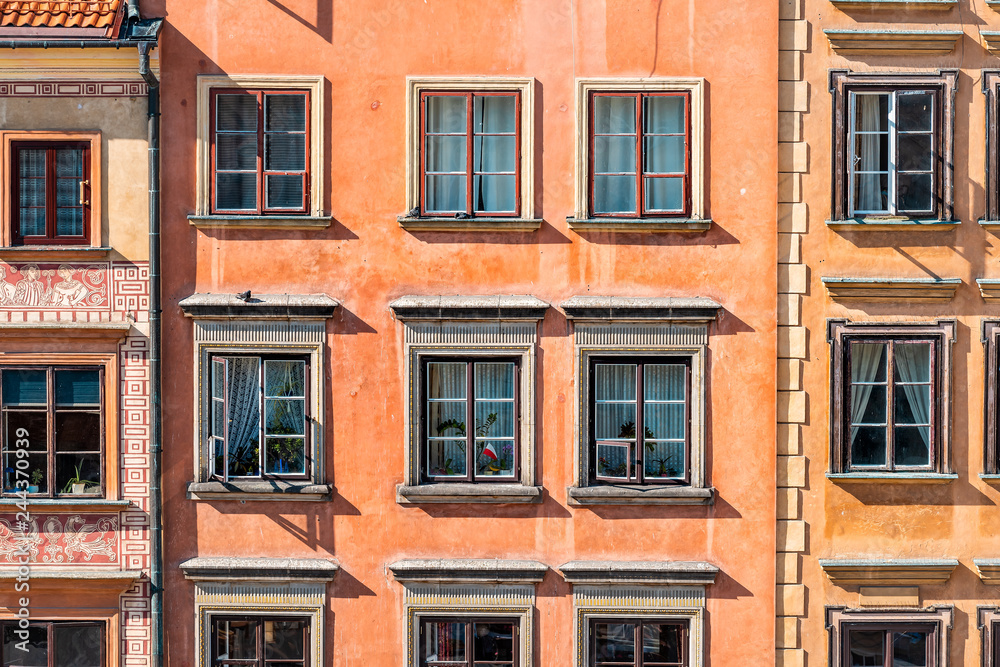 Warsaw, Poland old town market square with historic street town architecture and windows closeup pattern of red color