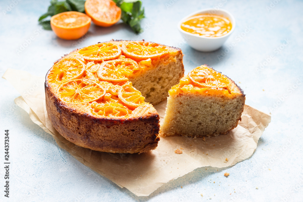 Upside down tangerine cake on a sky blue stone or concrete background. Upside down tangerine cake on a sky blue stone or concrete background.