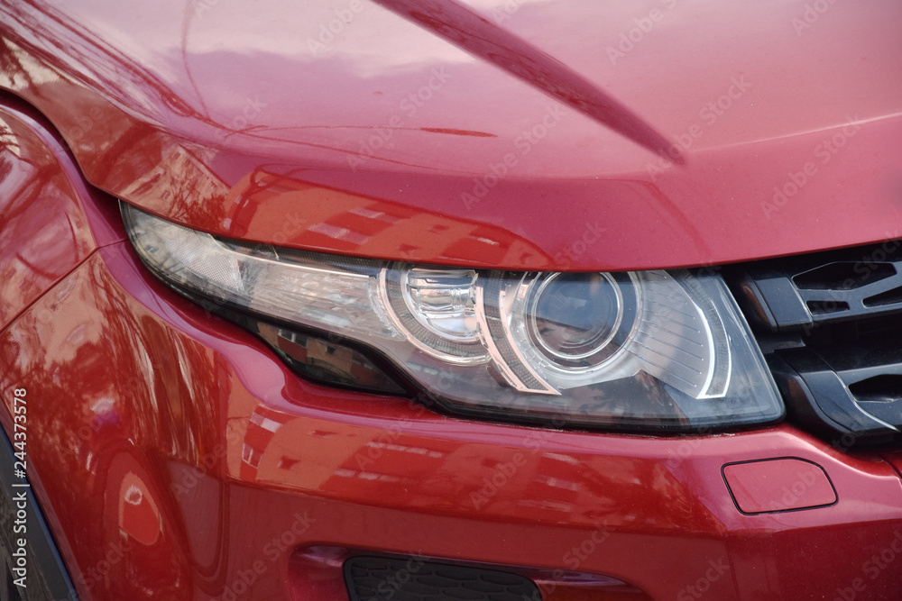 Car's exterior detail,new headlight on a  red car