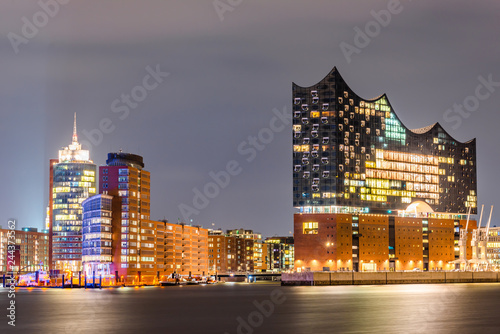 The famous Elbphilharmonie and Hamburg harbor at night photo