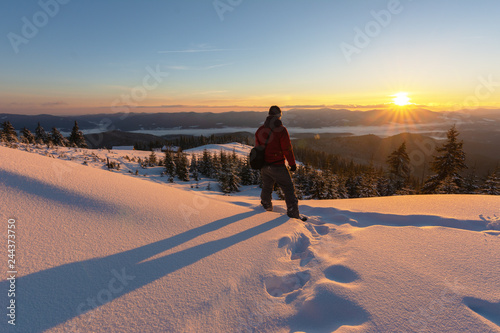 Motivating the image of man at the sunrise in the mountains.