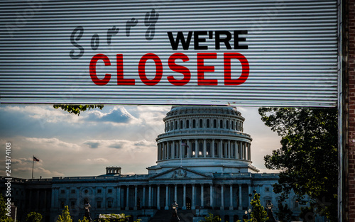 United States Capitol Building with a Old grunge weathered and dirty steel metal roller shutter door with Sorry we're closed text. USA shutdown and government closed concept photo