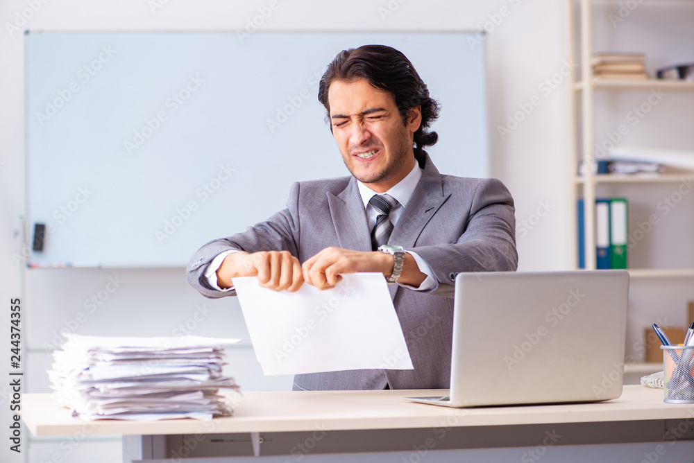Young handsome businessman employee in the office Young handsome businessman employee in the office