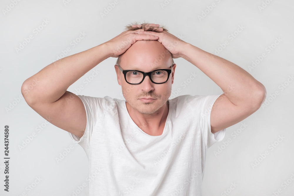 Man staring shocked and devestated at camera, feeling disappointment Man staring shocked and devestated at camera, feeling disappointment