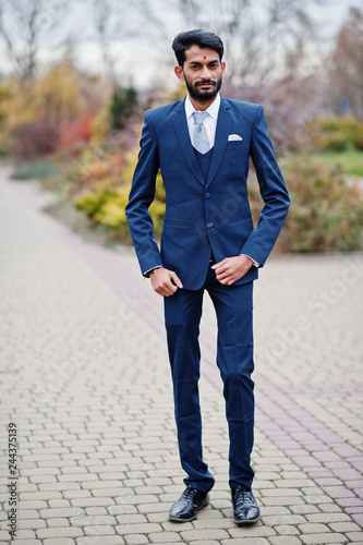 Stylish beard indian man with bindi on forehead, wear on blue suit posed outdoor. © AS Photo Family