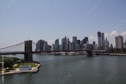The Brooklyn bridge connecting the financial district of Manhattan island with Brooklyn is a famous landmark  popular tourist attraction and travel destination in New York City