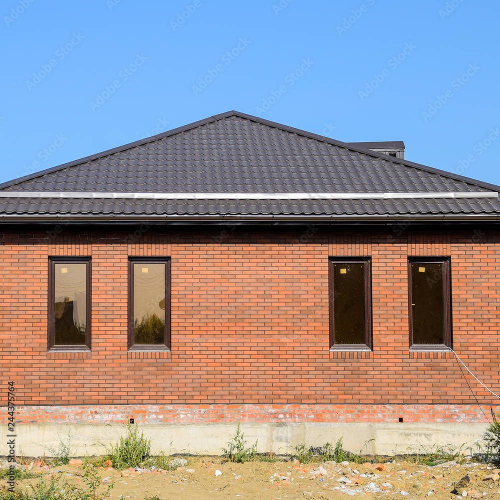 The house with plastic windows and a roof of corrugated sheet. B The house with plastic windows and a roof of corrugated sheet. B