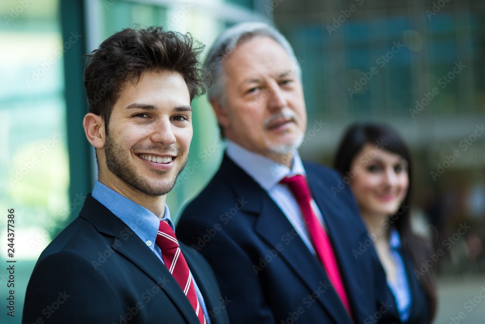 Business team smiling outdoor in a modern urban setting Business team smiling outdoor in a modern urban setting