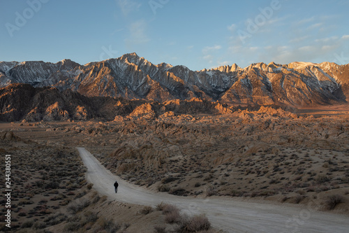 A traveler walking  during Sunrise at Alabama Hills, Lone Pine