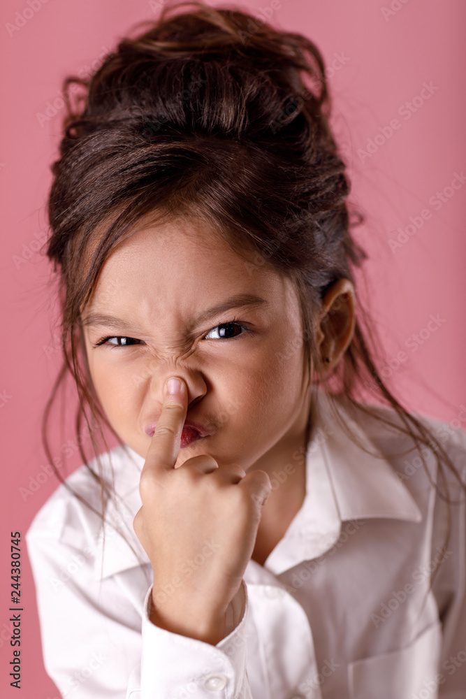 beautiful little girl in white shirt grimaces and fools beautiful little girl in white shirt grimaces and fools