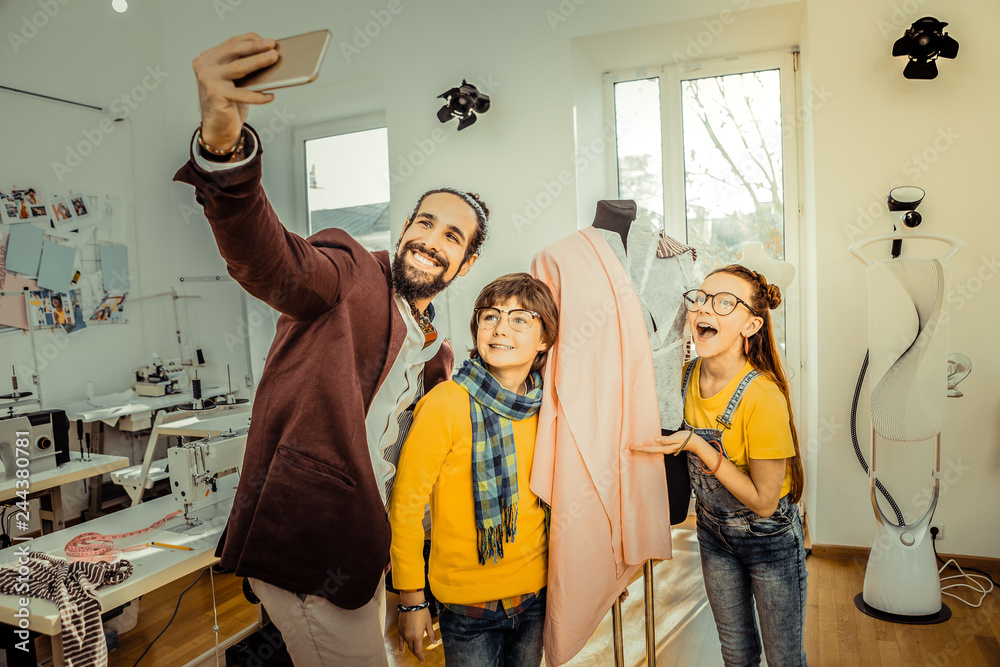Fototapeta premium Bearded father making selfie with his cute loving children