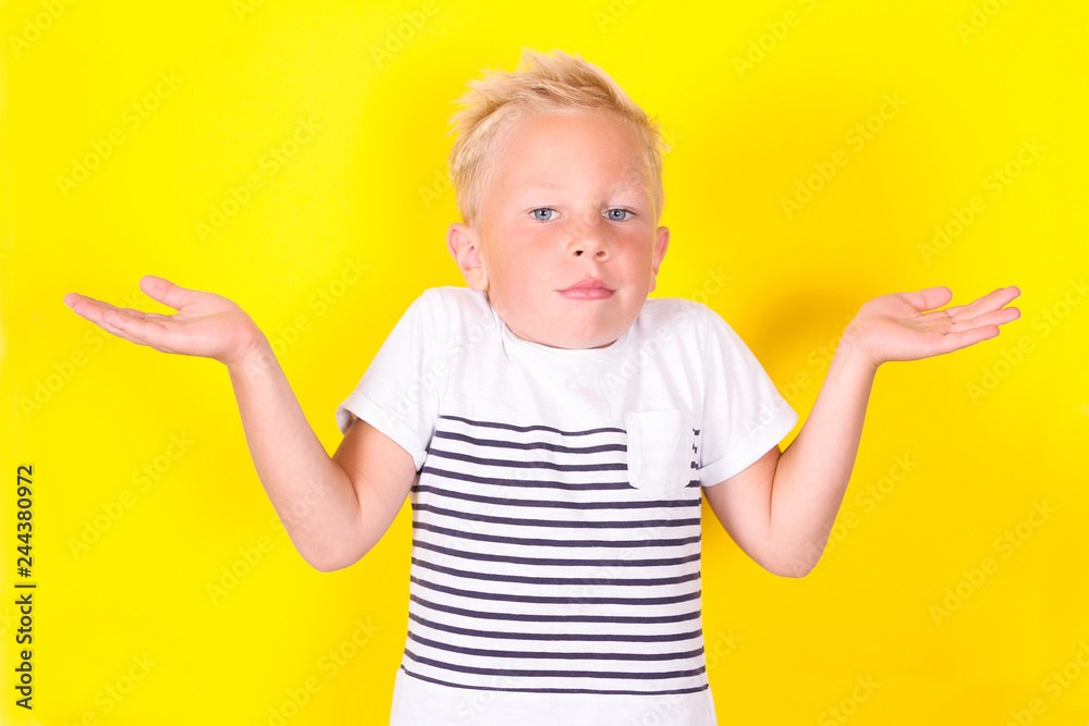 Cute blond boy portrait on yellow background Cute blond boy portrait on yellow background