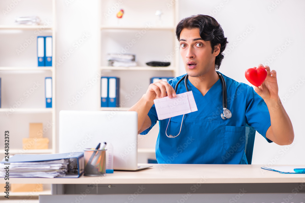 Young handsome doctor working at the clinic Young handsome doctor working at the clinic