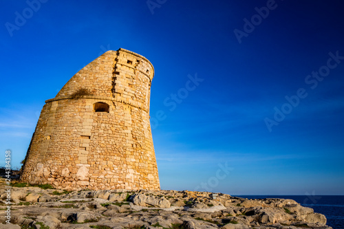 The ancient watch tower of Porto Miggiano, built on the cliffs overlooking the sea. Bleak and rocky landscape with a splendid view of the sea. Santa Cesarea Terme, Puglia, Salento, Italy.